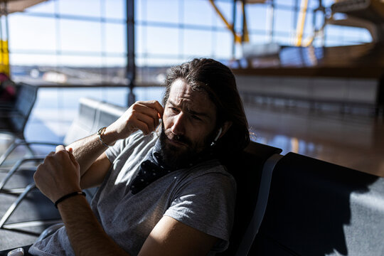 Man at airport bench while waiting for a flight