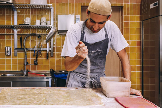 Cook sprinkling flour on dough