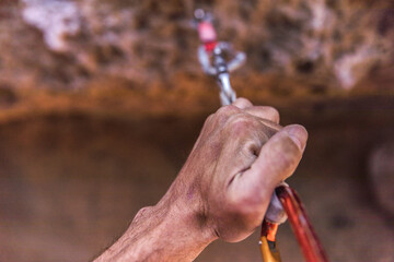 Hand of a climber holding a safety rope