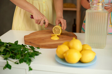 Make homemade lemonade with fresh yellow lemons and green mint