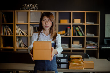 Young asian woman and online selling at home office, Startup small business owner working Online selling and product order for delivery to customer.