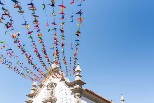 Old church facade under garlands in town