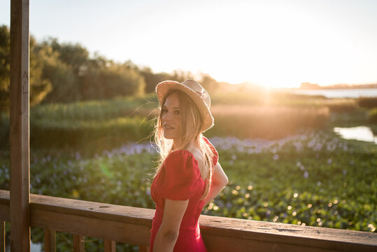 Woman admiring nature from veranda in evening