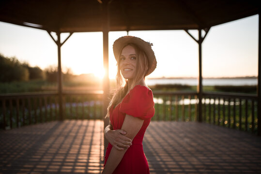 Woman admiring nature from veranda in evening