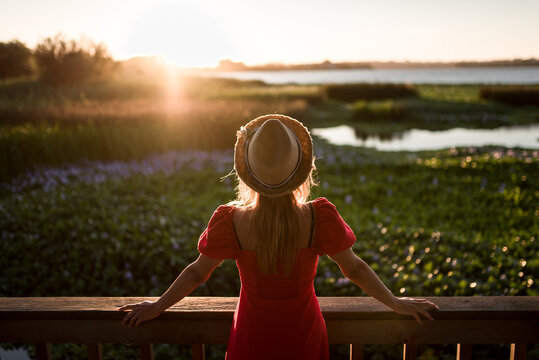Faceless traveler admiring nature from veranda in evening