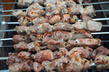 fresh pieces of meat are fried on skewers