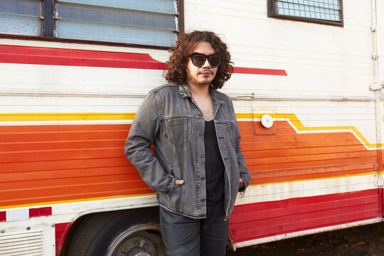 Homosexual man standing near van