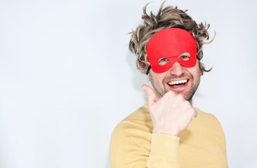 Funny man with a Flash mask on, indicating with a copy space for text.
