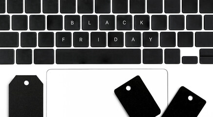 Keyboard with signs of shopping and black paper tags top view. Black Friday concept
