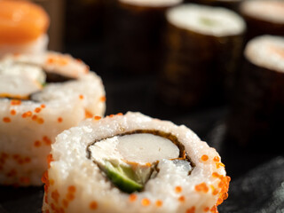 Japanese kitchen. Sushi on a dark background.