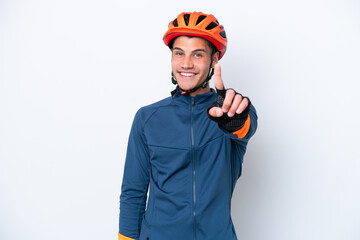 Young cyclist caucasian man isolated on white background showing and lifting a finger