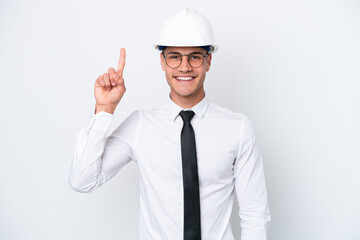 Young architect caucasian man with helmet and holding blueprints isolated on white background pointing up a great idea