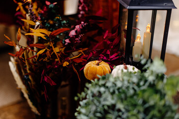 Faux velvet and lit up pumpkins as decor for a rustic wedding
