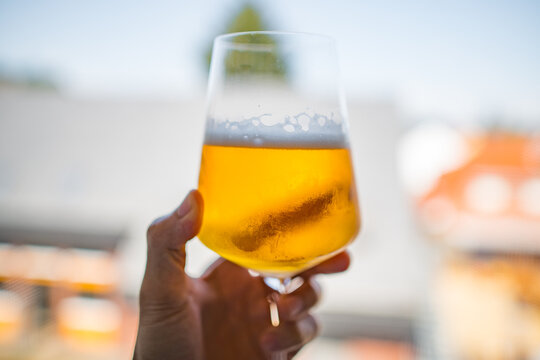 Hand holding a glass of beer
