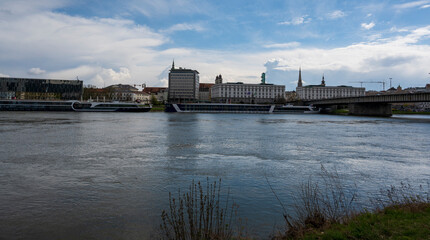 Panorama of the city behind the river with boats.