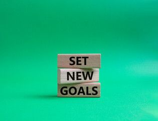 Set New Goals symbol. Wooden blocks with words Set New Goals. Beautiful green background. Business and Set New Goals concept. Copy space.
