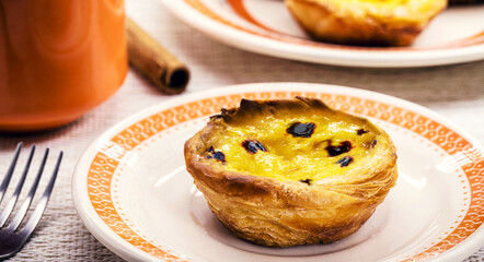 Portuguese Pastel de Nata, called Pastel de Belem, traditional Portuguese delicacy made with eggs, cinnamon and caramel