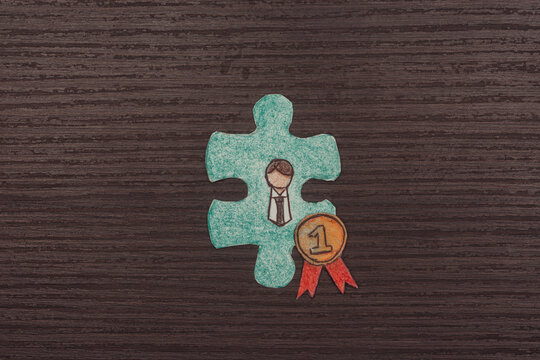 turquoise puzzle piece. Employee is elected employee of the month. He wears a number one ribbon medal. Business concept.