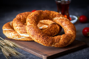 Turkish traditional bagel / simit with sesame on rustic table, turkish breakfast pastry concept - obrazy, fototapety, plakaty