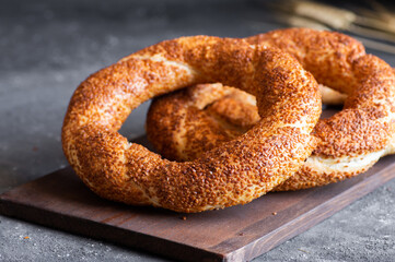 Turkish traditional bagel / simit with sesame on rustic table, turkish breakfast pastry concept