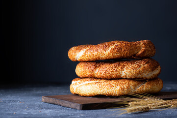 Turkish traditional bagel / simit with sesame on rustic table, turkish breakfast pastry concept