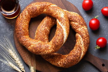 Turkish traditional bagel / simit with sesame on rustic table, turkish breakfast pastry concept
