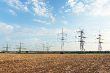 transmission tower overhead line masts, a lot of high-voltage power line, high voltage pylons also known as power pylons on the fields