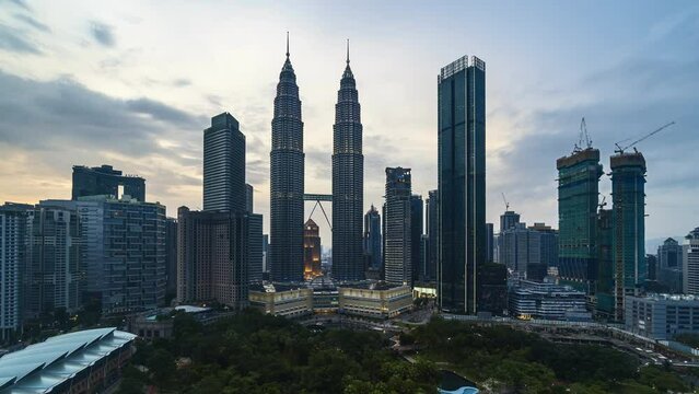Time-lapse 4k UHD footage of Petronas KLCC Twin Tower building with the color of Malaysia flag during independence day
