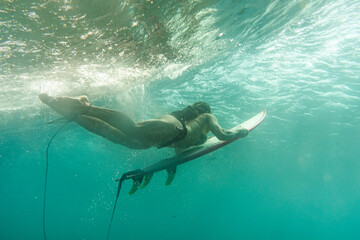 surfer under the wave  in maldives 