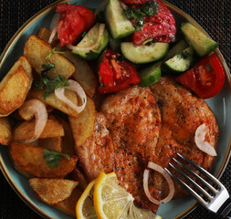 Langet, chop with vegetables on the sides. Shallow depth of field