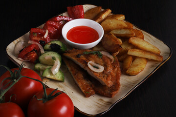Langet, chop with vegetables on the sides. Shallow depth of field
