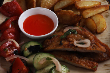 Langet, chop with vegetables on the sides. Shallow depth of field