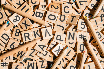 Wooden cubes laid out on the school blackboard with the text selective focus