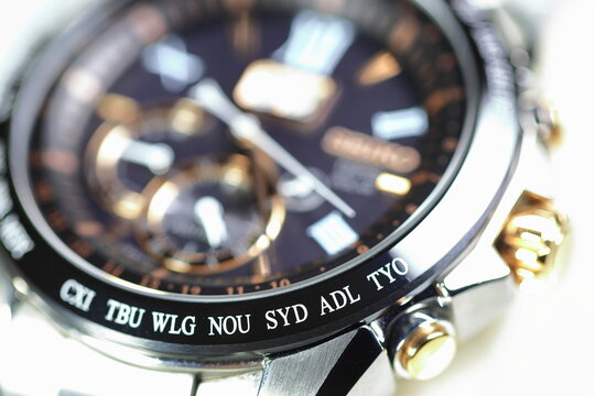 close up shallow focus Time zone cities code on luxury world time watch bezel on SYD Sydney, ADL Adelaide, NEU Neumea, TYO Tokyo.