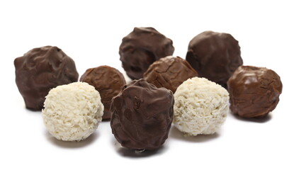 Round dark chocolates cream, milky hazelnut and white cream chocolates isolated on white