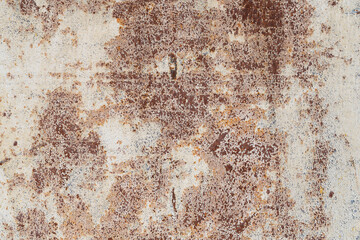 The surface of an old iron sheet with peeling paint. Numerous rust spots appear through the yellowed and destroyed layer of paint. Background. Texture.