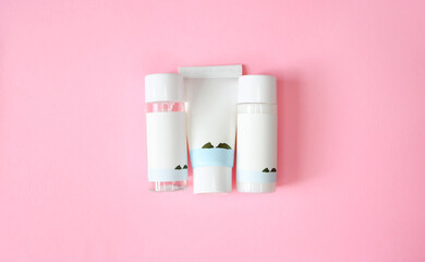 Set of travel size mini cosmetic beauty products lotion, tonic, cream, cleanser, essence. No label. Isolated on pink background. Beauty mock up.