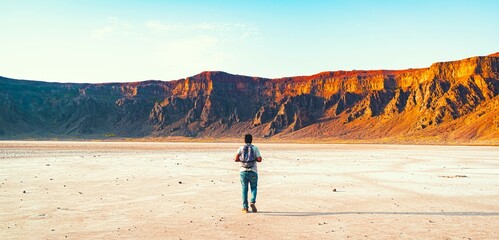 Person walking in a volcanic crater. An image from Wahbah Crater, Saudi Arabia