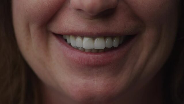 Close up perfect smile of a senior caucasian woman in slow motion
