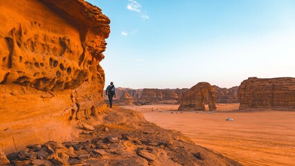 Man hiking in a desert valley. An image from Al Ula, Saudi Arabia.
