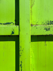 Closeup of a green garbage bin and abstract cross. Concept of environmentalism, religion and climate change denial.
