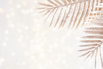 Shiny gradient background with golden palm leaf and bokeh.
