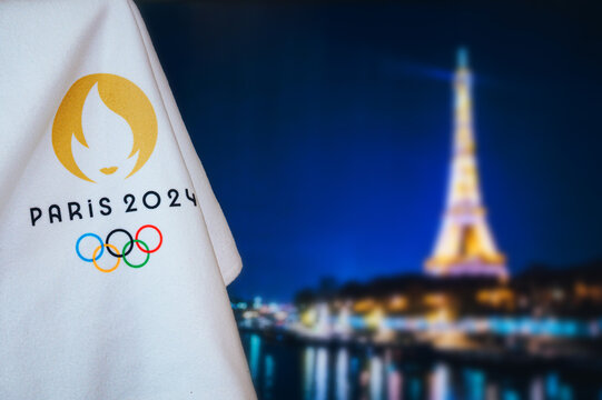 PARIS, FRANCE, AUGUST 8. 2022: Summer olympic game Paris 2024 black background. Official logo of SOG 2024 in Paris on white blanket with dark City in night. Black edit space, sport event