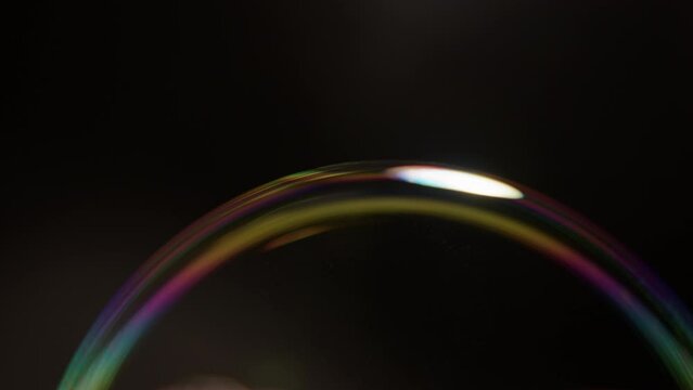 soap bubble with rainbow transfusion bursts slow motion