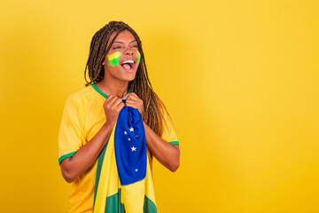 black woman young brazilian soccer fan. holding brazil flag, anxious, watching the match. - obrazy, fototapety, plakaty