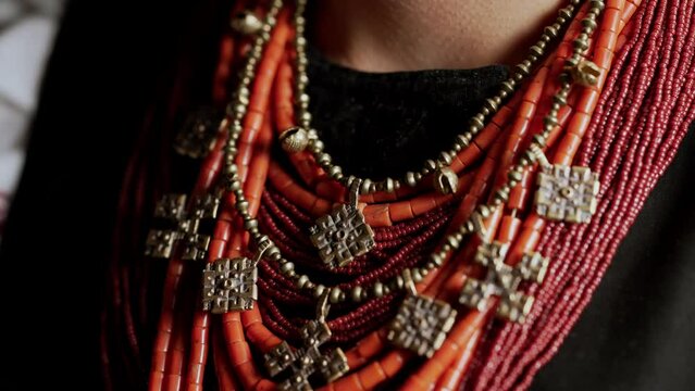 Demonstrating traditional antique jewelry necklace. National costume of Ukraine. Ukrainian woman in legacy ancient coral beads, Zgarda - archaic hutsul neck ornament of status religious purpose