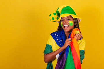black woman young brazilian soccer fan. Holding LGBTQ Flag, Militancy, LGBT Pride, lesbian....