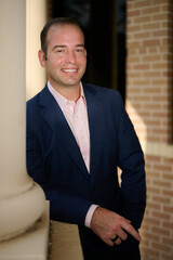 Fototapeta premium THE WOODLANDS, TEXAS - SEPTEMBER 1ST 2022: Doctor is posing in a suit for environmental portraits at his medical office The Woodlands Plastic Surgery to promote his business at Living Magazine