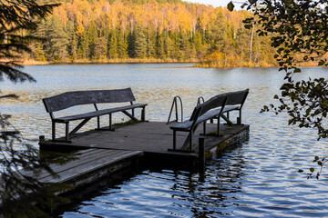 Obraz premium pier with benches on a forest lake in the autumn forest. Naroch Park Blue Lakes