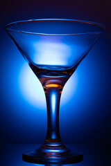 Colorful orange-red and navy blue Cocktail In Martini Glass On Background At Party. Selective Focus.